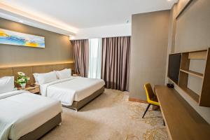 Postel nebo postele na pokoji v ubytování GRAND FLORA HOTEL