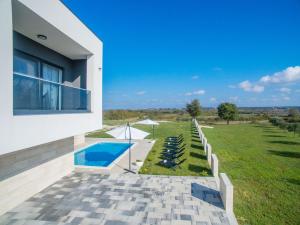 a house with a swimming pool next to a yard at Villa F&A ZadarVillas in Donje Raštane +29 photos