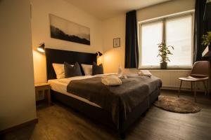 a bedroom with a bed and a chair at Le Bistro in Valkenburg