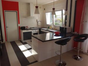 a kitchen with a counter and two bar stools at CAL41 in Calafat