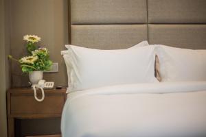 Postel nebo postele na pokoji v ubytování GRAND FLORA HOTEL