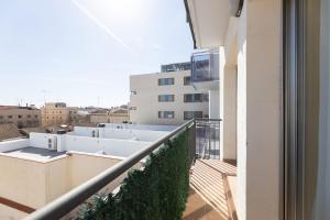 a balcony with a view of a building at matarolux18 in Mataró