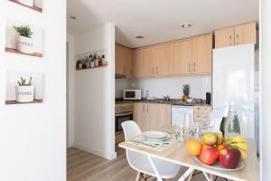 a kitchen with a table with fruit on it at matarolux18 in Mataró +12 photos
