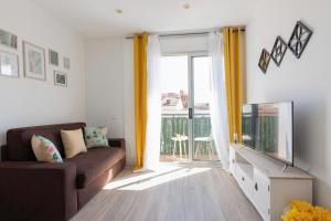 a living room with a couch and a sliding glass door at matarolux18 in Mataró