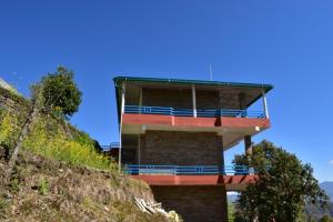 a building on the side of a hill at Rudra Himalayan Retreat in Almora