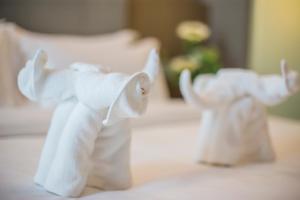 Postel nebo postele na pokoji v ubytování GRAND FLORA HOTEL