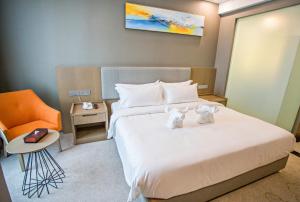Postel nebo postele na pokoji v ubytování GRAND FLORA HOTEL