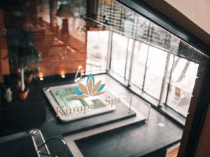 a sign on a table in front of a window at Hotel Kumpeli Spa in Heinola