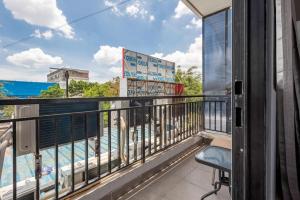a balcony with a chair and a swimming pool at RedDoorz near Tanjung Duren 2 in Jakarta