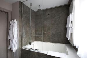 a bathroom with a shower with a bath tub at Palace Hotel Moderno in Pordenone +42 photos