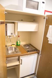 a small kitchen with a sink and a microwave at Vienna4you App 10 you are welcome in Vienna