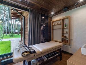 a bed in a room with a large window at Мис Доброї Надії Полтава in Hlody +83 photos