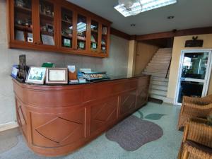 a lobby with a large wooden counter in a building at Samran Residence in Krabi