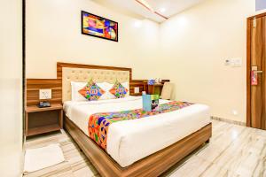 a bedroom with a large bed in a room at FabHotel Axis International in Mumbai
