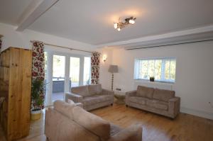 a living room with two chairs and a couch at Lakeside Old Hunstanton in Hunstanton