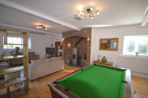 a living room with a pool table in it at Lakeside Old Hunstanton in Hunstanton