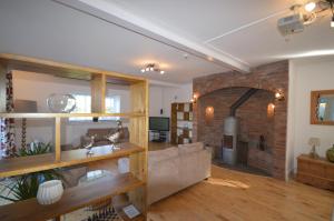 a living room with a couch and a brick wall at Lakeside Old Hunstanton in Hunstanton