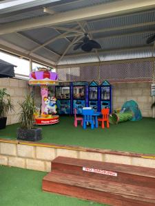 a room with a play area with tables and chairs at Riverside Hotel in Northam