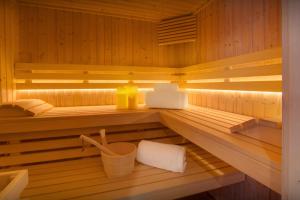 a sauna with a towel and a yellow container in it at Chalet Goville - OVO Network in La Giettaz