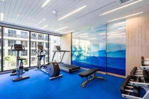 a gym with blue flooring and a large window at Maven Stylish Hotel Hua Hin in Hua Hin