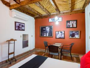 een eetkamer met oranje muren en een tafel en stoelen bij Hotel Olimpia in Monclova
