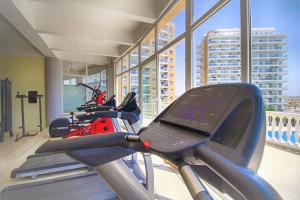 a gym with several motorcycles on a treadmill at Ceasar Resort Cyprus - Apartment Leona in Bahçeler