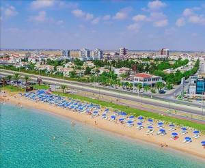 an aerial view of a beach with umbrellas and the ocean at Ceasar Resort Cyprus - Apartment Leona in Bahçeler