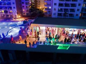 a group of people standing around a ice rink at night at Ceasar Resort Cyprus - Apartment Leona in Bahçeler +72 photos