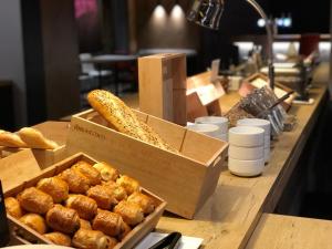 a counter with boxes of bread and other pastries at ibis Melun in Melun