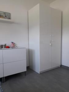 a white kitchen with white cabinets and a table at Privatzimmer Essy in RE in Recklinghausen