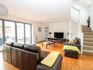 a living room with a couch and a television at Tenison House in North Walsham