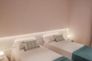 A bed or beds in a room at The Boc Suites