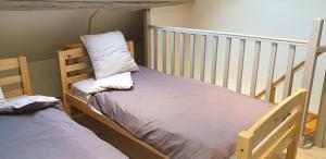 two bunk beds in a room with a crib at La petite maison in Saint-Georges-sur-Cher