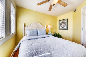 a bedroom with a bed and a ceiling fan at Tybee Escape in Tybee Island