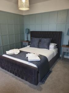 a large bed with two towels on it in a room at Rooms at The Dressers Arms in Chorley