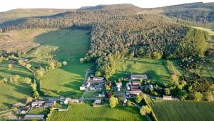 an aerial view of a house in a field at Country Getaway - Tosson Tower Farm in Rothbury