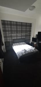 A bed or beds in a room at The Lodge Guest Accommodation 