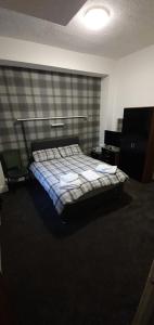 A bed or beds in a room at The Lodge Guest Accommodation 