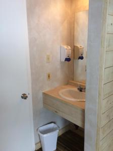 a bathroom with a sink and a mirror at Motel du Bic in Bic +23 photos