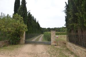 a gate to a driveway with a fence at VILLAS COSETTE Molí d'en Tarrés in Santa Cristina d'Aro