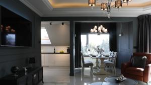 a dining room with a table and chairs and a chandelier at Czantoria View Apartment Ustroń in Ustroń