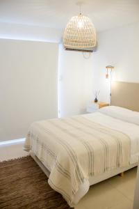 a white bedroom with a bed and a pendant light at san francisco loft 2 in San Francisco