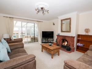 a living room with a couch and a fireplace at 2 Fieldview in Alford