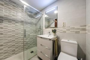 a bathroom with a toilet and a sink and a shower at Apartamentos Marina sol de España in Cambrils +79 photos