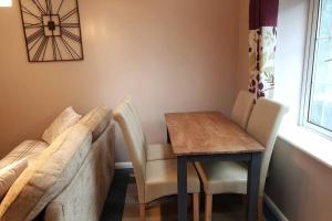 a living room with a table and chairs and a couch at Otters' Raft in Weston-super-Mare