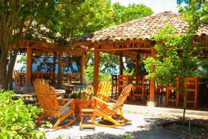 a group of chairs sitting in front of a gazebo at Hotel San Juan Ometepe in Altagracia