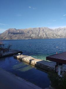 a large body of water with mountains in the background at Apartments Vila Marija in Kotor