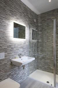 a bathroom with a sink and a shower at Railway Apartments in Nailsworth