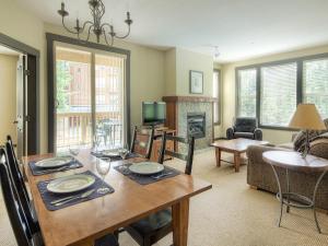 a dining room with a table and a living room at Panorama Mountain Resort - Ski Tip / Tamarack Condos in Panorama