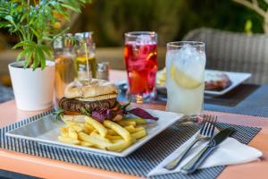 a plate with a hamburger and french fries on a table at Alcudia Petit - Turismo de Interior in Alcudia